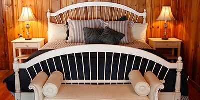 a bed in a log cabin